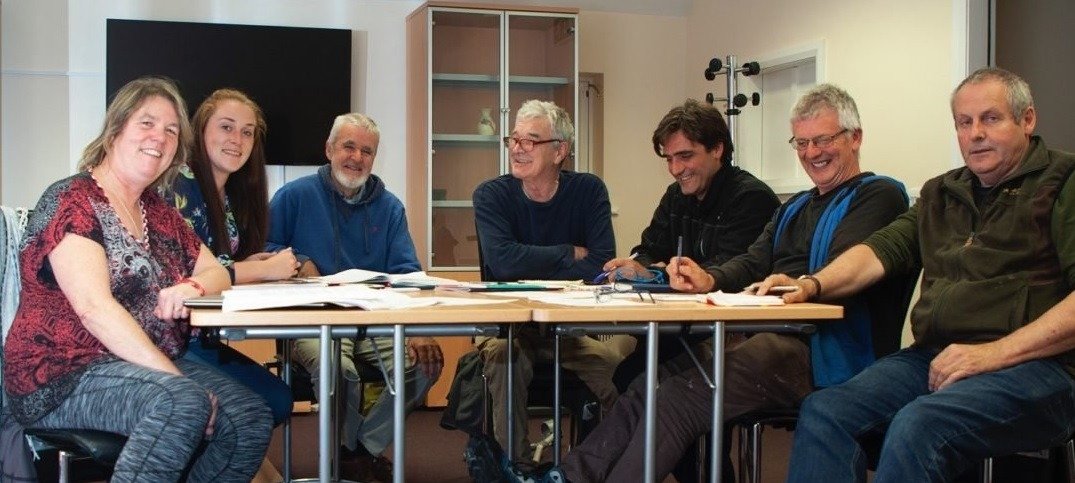 CFOAT committee members seated at table looking at camera